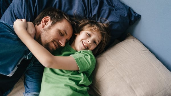 Father and son playing on the sofa
