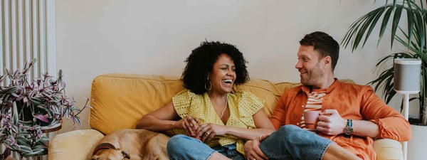 Man and woman sitting on sofa