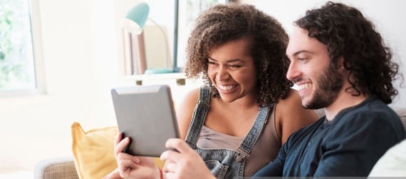 Young couple looking at tablet computer