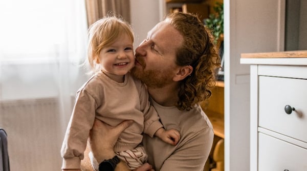 Father hugging toddler daughter