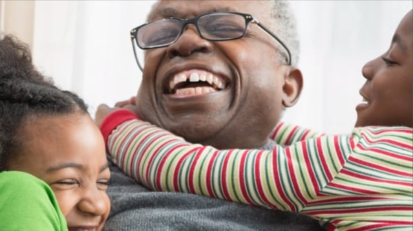 Man playing with grandchildren