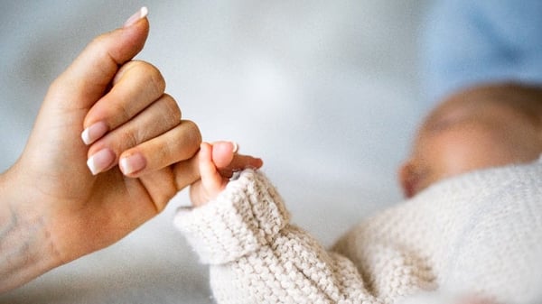Mum and baby daughter holding hands