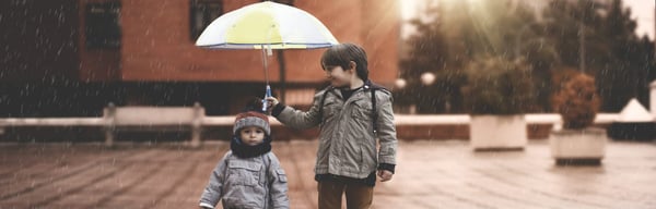 Brothers under umbrella