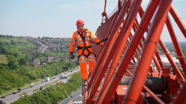 A man on top of a bridge showing dangerous jobs in the UK