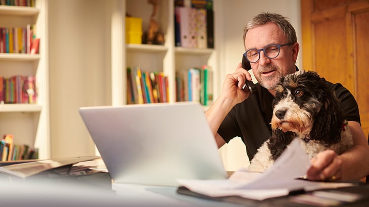 Man on phone with dog